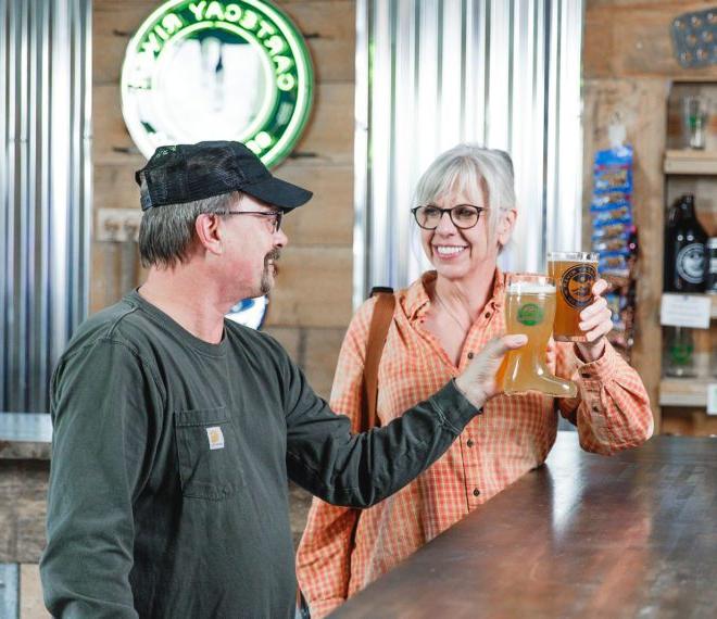 Man and woman enjoying pints of beer